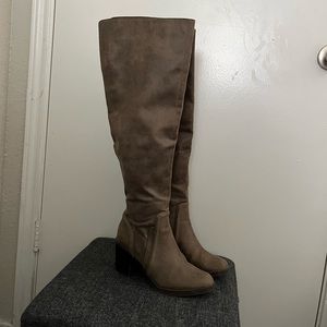 Brown thigh high boots.